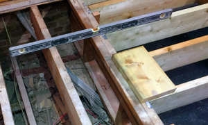 Spirit level on exposed timber suspended floor